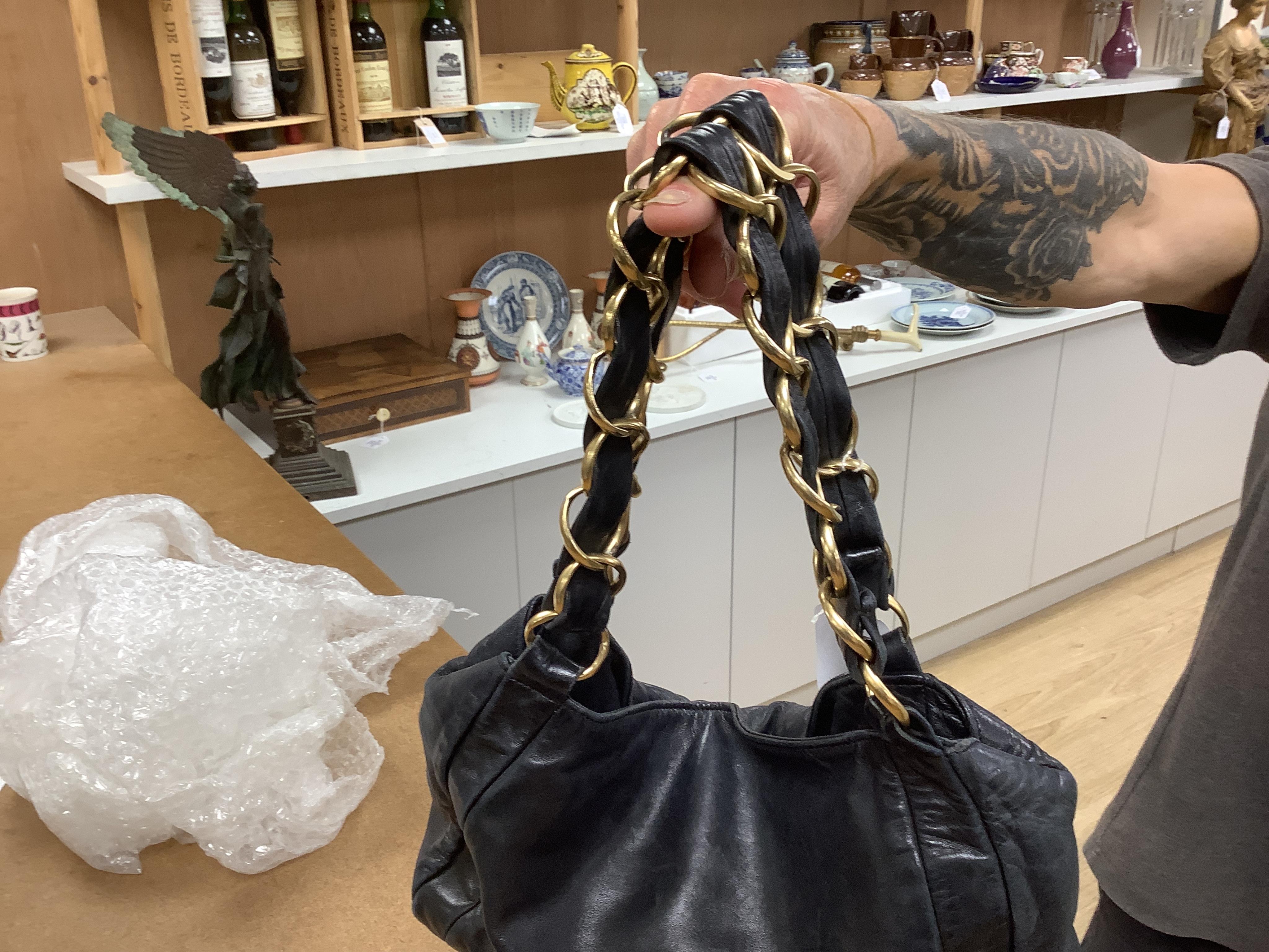 An early 2000’s Chanel black leather handbag with gold hardware, date code 7949937, 31cm wide